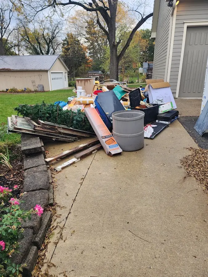 Dumpster being loaded with debris for 3 Yard Dumpster Rental in Bergenfield